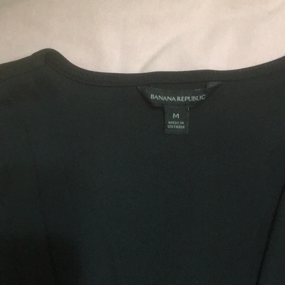 Black sleeveless V neck blouse.